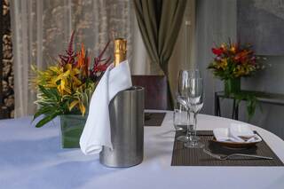 A platter featuring three types of sashimi on a bed of ice, garnished with greens and edible flowers, presenting a vibrant feast.