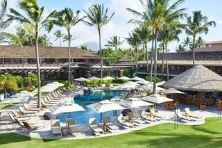 A serene tropical resort features a sparkling pool surrounded by lounge chairs, palm trees, and a thatched-roof bar, creating a relaxing atmosphere.