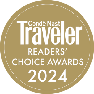 A circular badge featuring "Condé Nast Traveler Readers' Choice Awards 2024" in bold white lettering on a gold background.