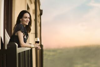 A man and a woman relax on lounge chairs in a pool, enjoying the sun and each other's company on a warm day.