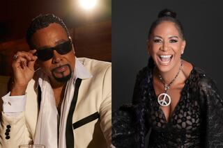 A stylish man in sunglasses and a tuxedo poses confidently, while a smiling woman in a detailed black outfit showcases a peace symbol necklace.